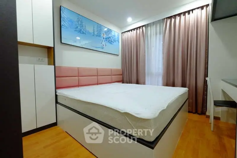 Modern bedroom with stylish decor and natural light, featuring a comfortable bed and elegant curtains.