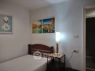 Cozy bedroom with single bed and artistic wall decor