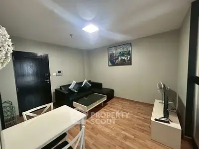 Modern living room with sleek furniture and wooden flooring