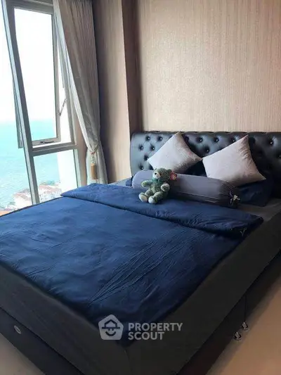 Cozy bedroom with ocean view, plush bedding, and elegant decor for a serene living experience.