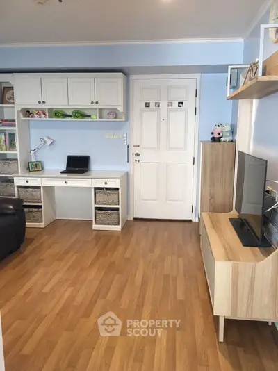Charming study area with modern desk and TV in cozy living space.