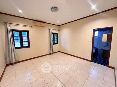 Spacious unfurnished room with tiled floor and adjacent bathroom