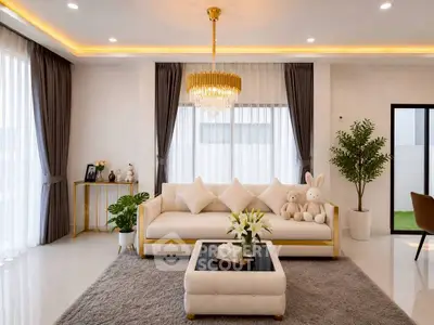 Luxurious living room with elegant chandelier and plush seating in modern home.