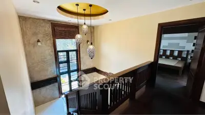 Elegant staircase with modern lighting and wooden railing in a stylish home interior.