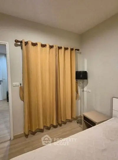Cozy bedroom with warm curtains and modern lamp