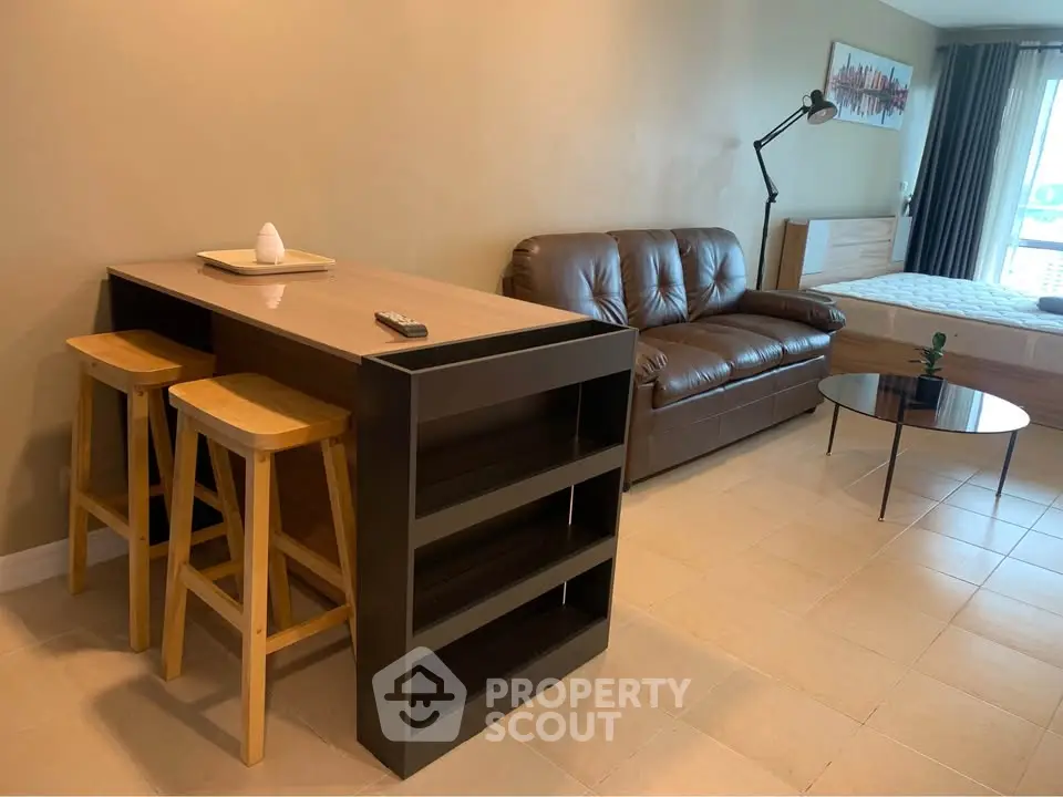 Modern studio apartment with cozy living area and stylish furniture