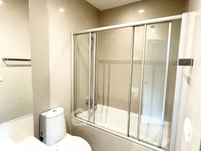 Modern bathroom with glass shower enclosure and sleek fixtures