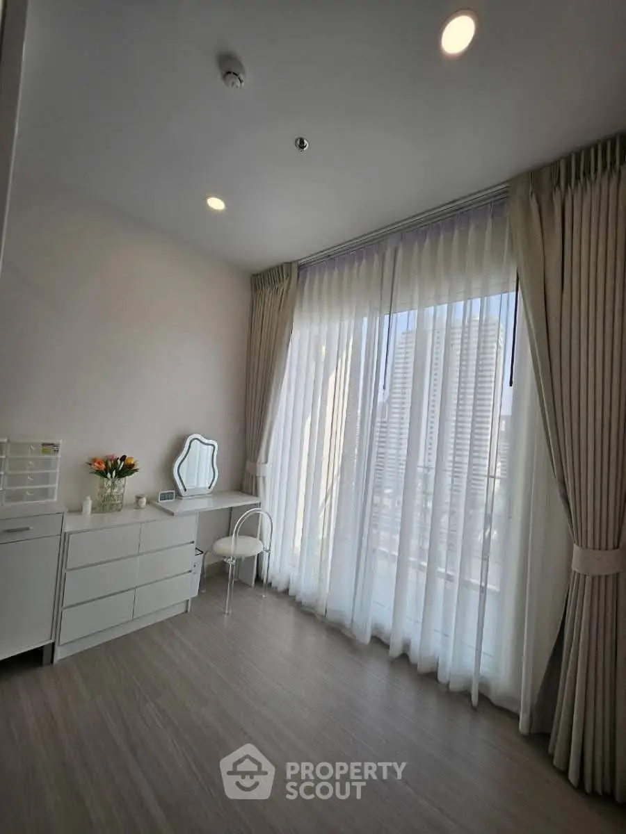 Bright and airy room with large windows and city view, perfect for a modern home.