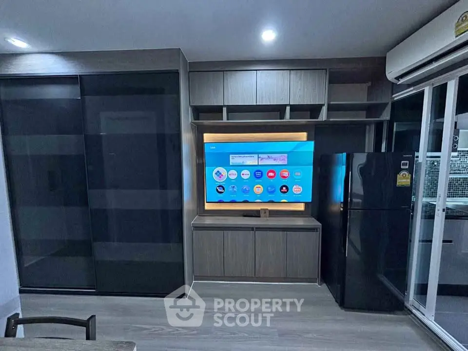 Modern living room with sleek entertainment center and large refrigerator