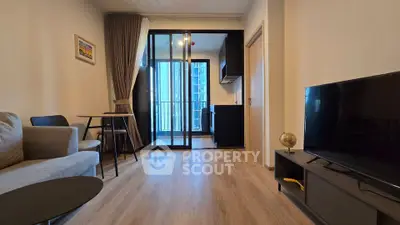 Modern living room with open kitchen and balcony view in stylish apartment