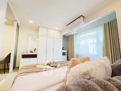 Luxurious bedroom with modern decor and ample natural light