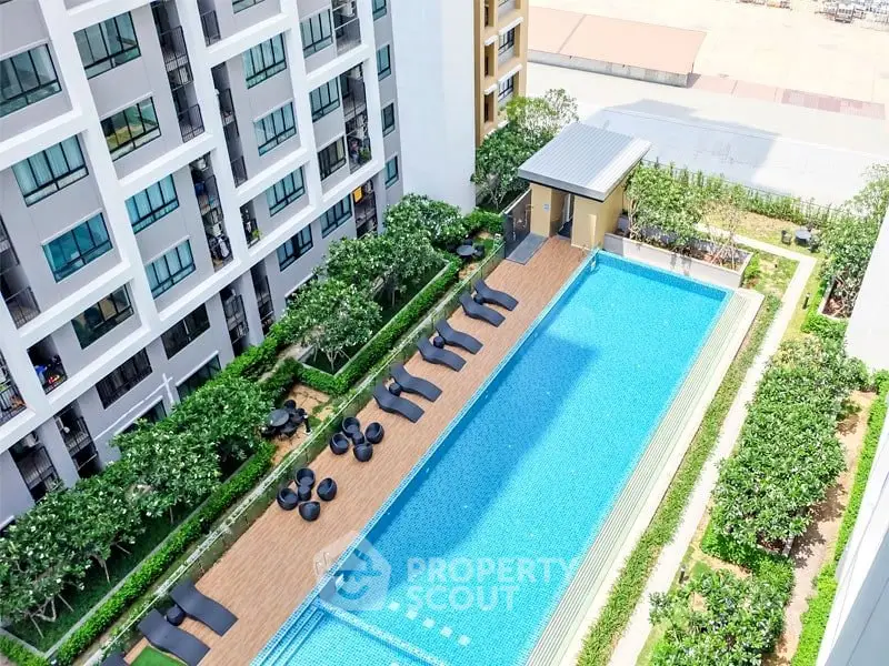 Luxurious apartment complex with stunning pool and lush greenery, perfect for relaxation and leisure.