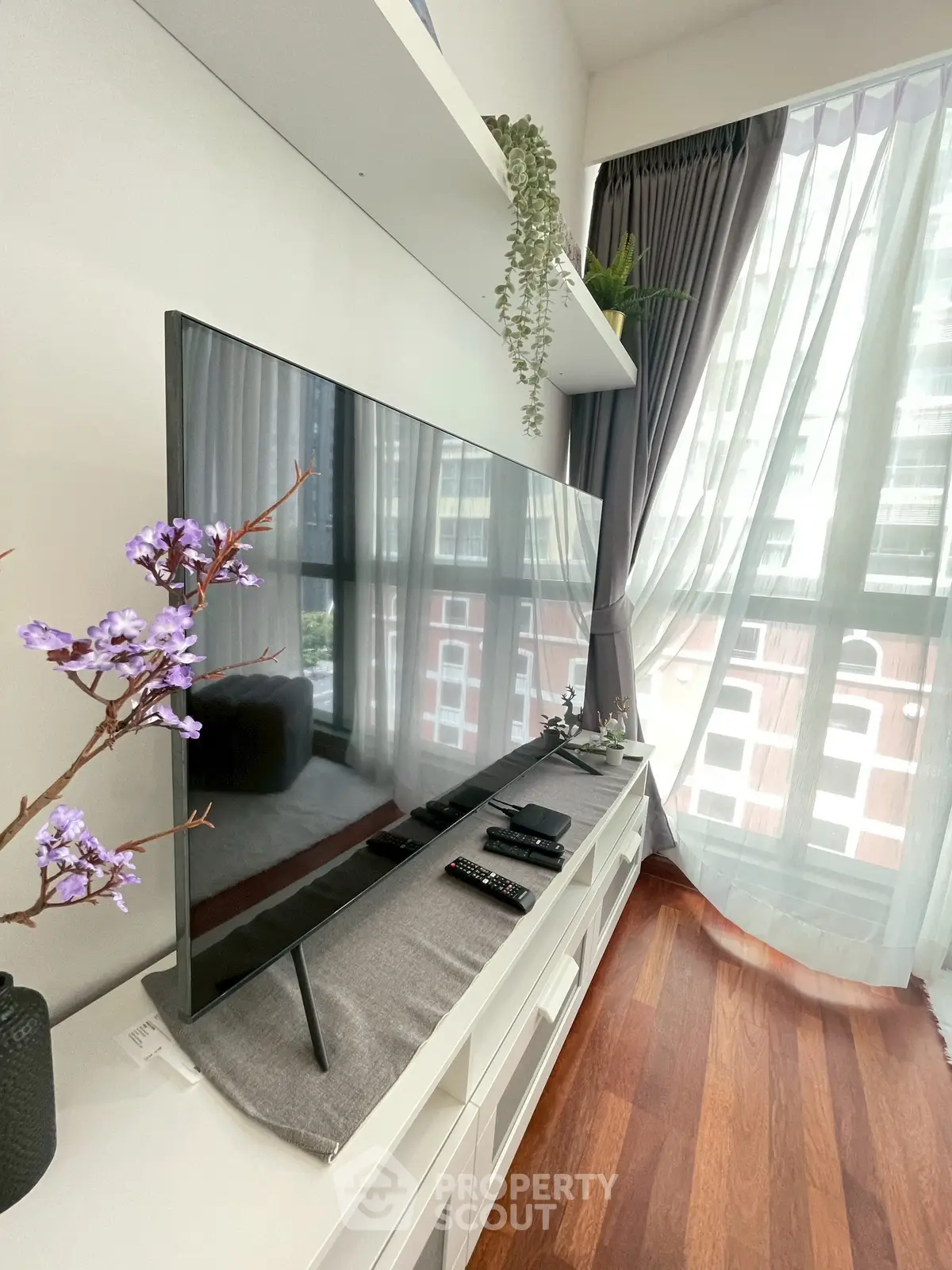 Modern living room with sleek TV setup and large window view