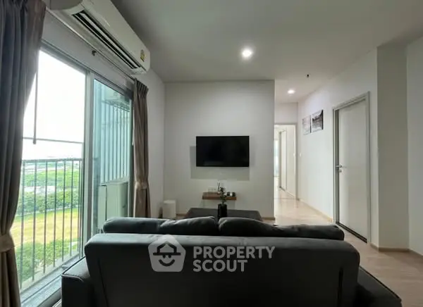 Modern living room with balcony view and sleek interior design