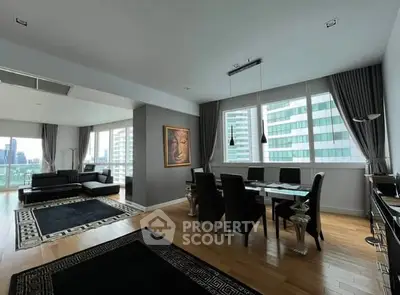 Spacious modern living room with dining area and city view, featuring elegant decor and large windows.