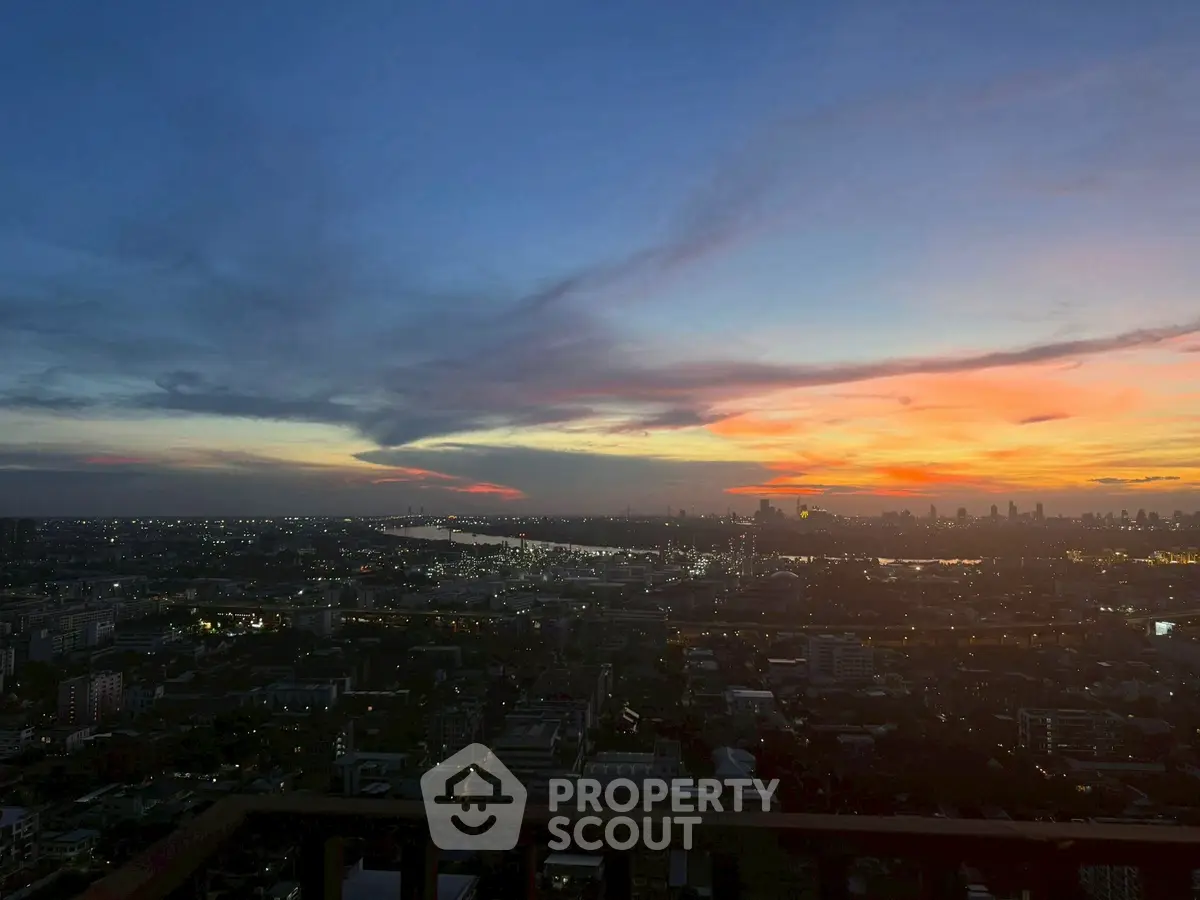 Stunning cityscape view at sunset from a high-rise balcony, perfect for urban living.