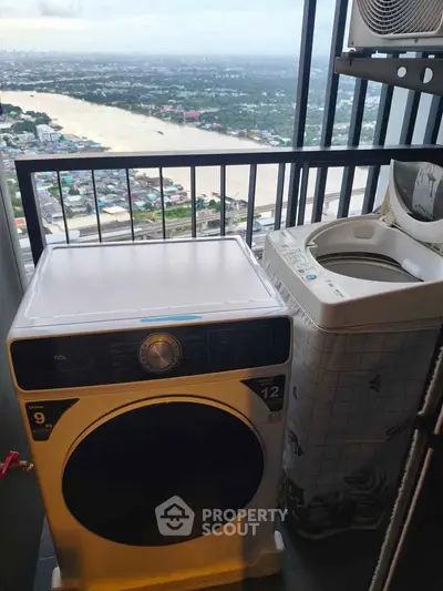 High-rise balcony with washing machines and stunning river view