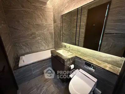 Luxurious modern bathroom with elegant stone tiles and sleek fixtures