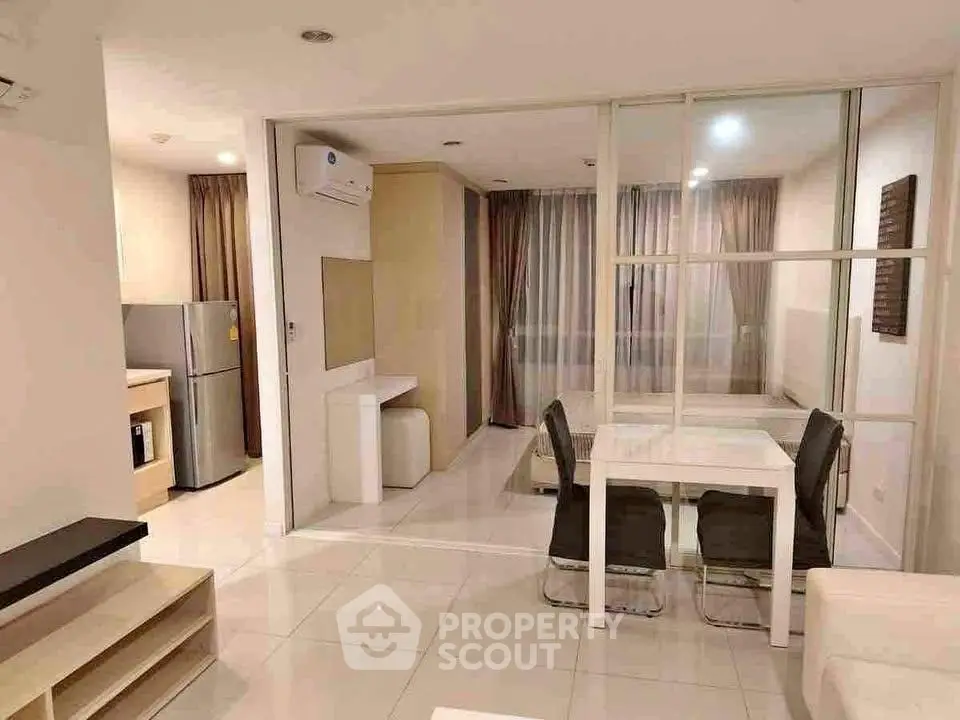 Modern open-plan living and dining area with sleek furnishings and natural light.