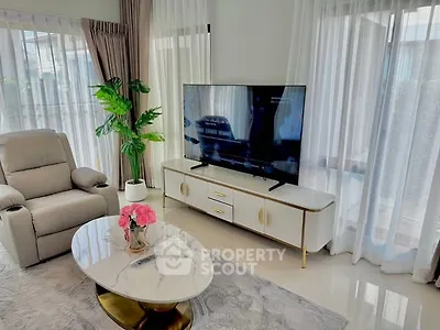 Elegant living room with modern TV setup and stylish furniture