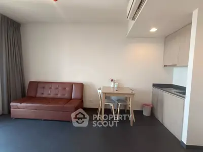 Modern studio apartment with sleek kitchen and cozy living area