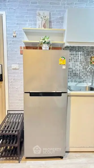 Modern kitchen with sleek stainless steel fridge and stylish backsplash
