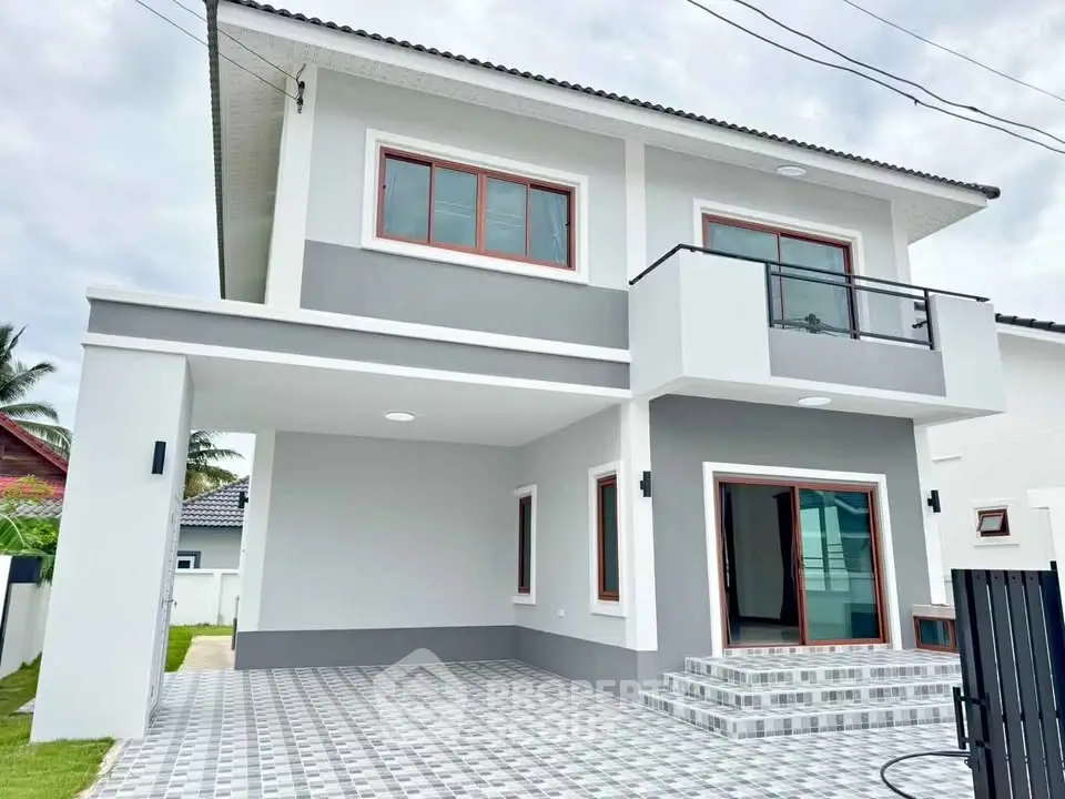 Modern two-story house with stylish balcony and spacious driveway