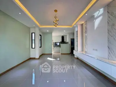 Spacious modern living room with elegant lighting and sleek tile flooring
