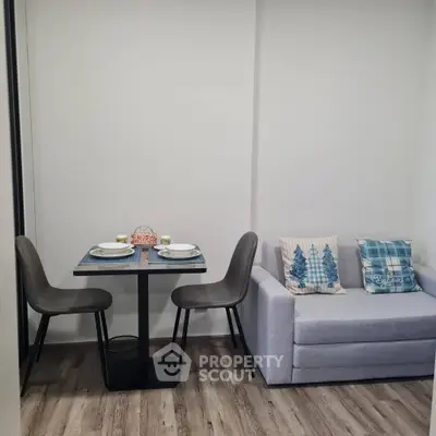 Cozy living room with modern dining set and stylish sofa, perfect for urban living.