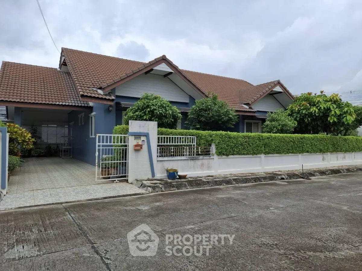 Charming suburban home with lush greenery and tiled roof, perfect for family living.