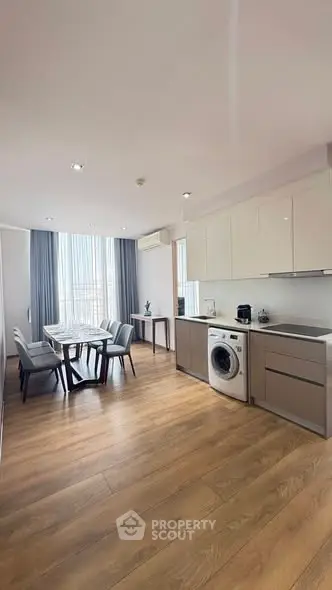 Modern open-plan kitchen and dining area with sleek design and natural light.