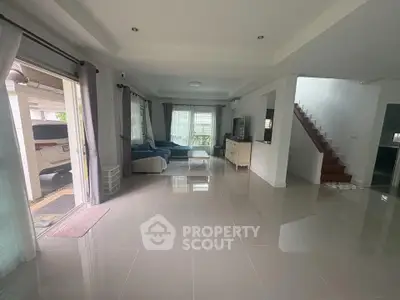 Spacious modern living room with sleek tile flooring and natural light