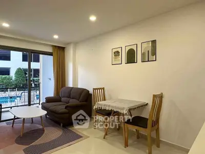 Modern living room with cozy sofa and dining area overlooking pool view