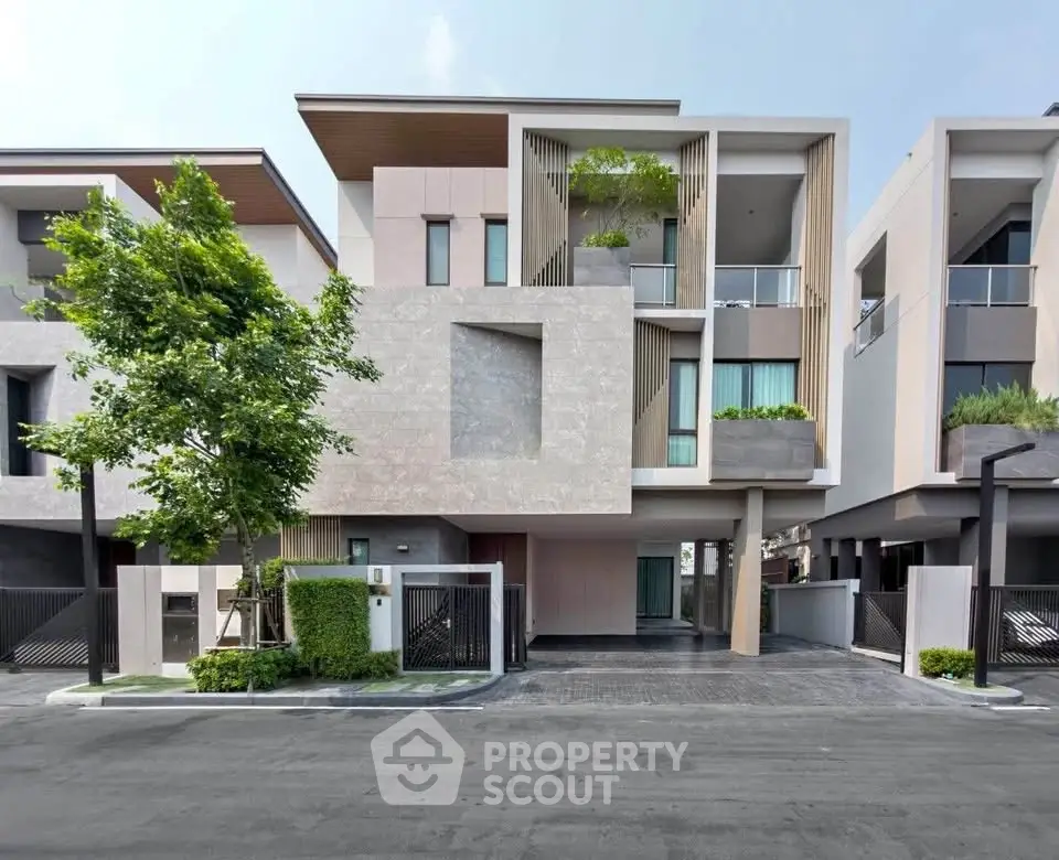 Modern three-story townhouse with sleek design and lush greenery in a serene neighborhood.