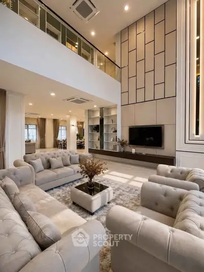 Luxurious double-height living room with elegant sofas and modern decor