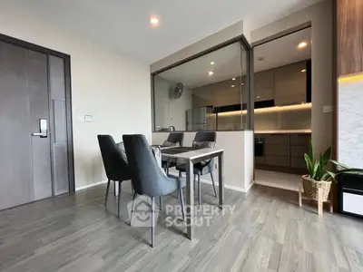 Modern dining area with sleek kitchen and stylish decor