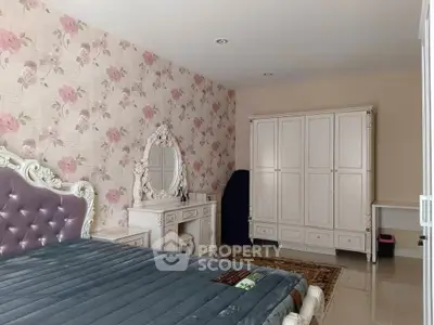Elegant bedroom with floral wallpaper and classic white furniture