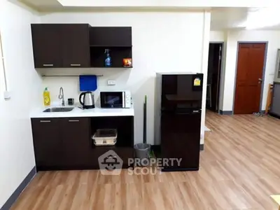 Compact kitchen with modern appliances and wooden flooring
