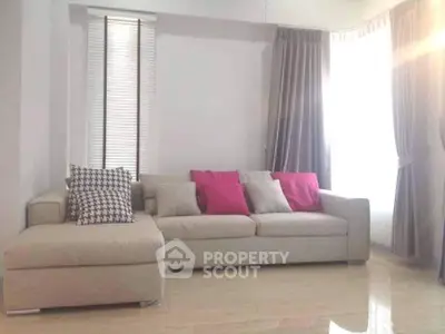 Spacious living room with modern beige sofa and stylish curtains