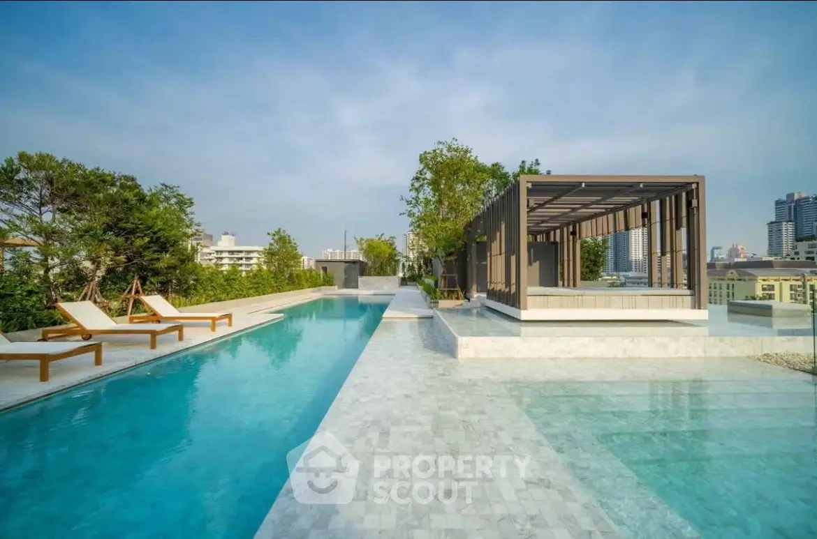 Luxurious rooftop pool with city views and modern cabana, perfect for relaxation.