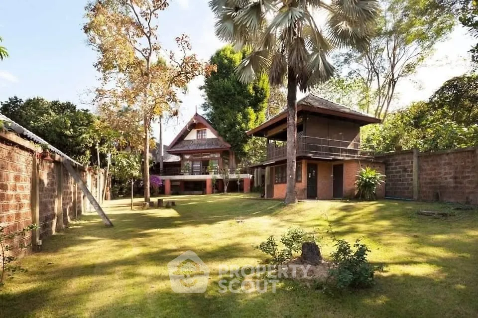 Charming rustic house with lush garden and spacious lawn, perfect for serene living.
