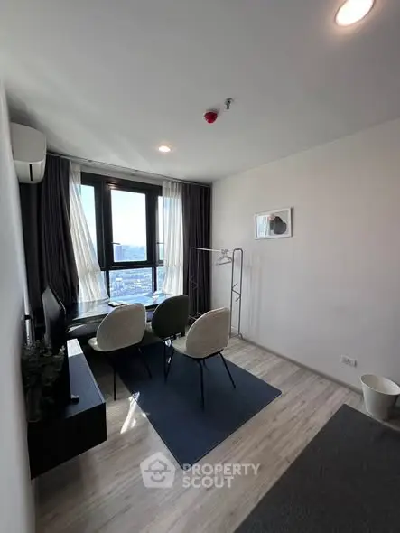 Modern living room with city view, stylish furniture, and natural light.