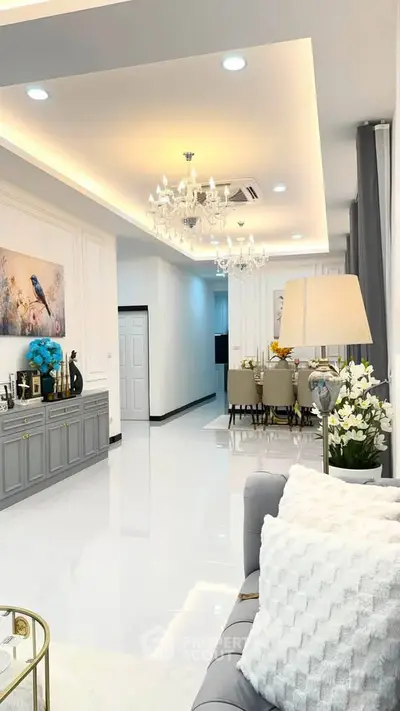 Luxurious living room with elegant chandeliers and modern decor