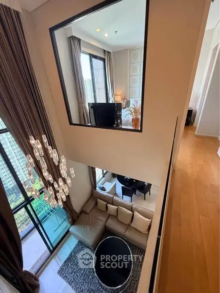 Luxurious high-ceiling living room with modern decor and large windows offering stunning city views.