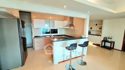 Modern open-layout kitchen with sleek design and breakfast bar in a bright apartment.