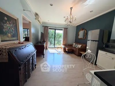Charming living room with elegant decor and natural light, featuring a cozy seating area and modern kitchen.