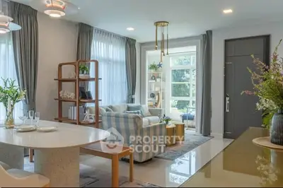 Elegant living room with modern decor, large windows, and stylish furniture in a bright, inviting space.