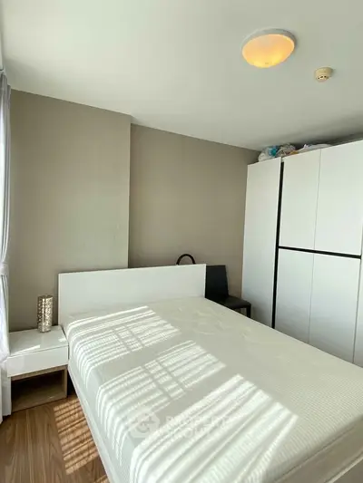Bright and cozy bedroom with modern furniture and ample natural light.