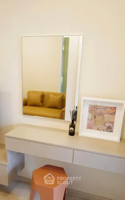 Modern interior with stylish mirror and cozy seating area, perfect for contemporary living spaces.