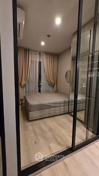 Modern bedroom with glass partition and elegant curtains